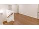 Open landing space featuring hardwood floors and classic trimwork at 6565 Rhett Run, Cumming, GA 30028