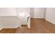 Second floor landing with light hardwood floors and doors at 6565 Rhett Run, Cumming, GA 30028