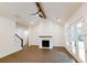 Open-concept living room featuring a cozy brick fireplace, ceiling fan, and natural lighting at 6565 Rhett Run, Cumming, GA 30028