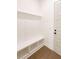This mudroom features built in shelving, a bench, tile floors, and an exterior door at 6565 Rhett Run, Cumming, GA 30028