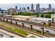 Aerial view showcasing the city skyline, train tracks with a passing train, and storage facilities at 170 Boulevard Se # E006, Atlanta, GA 30312