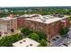 Stunning aerial view of multiple red brick apartment buildings with trees and parking at 170 Boulevard Se # E006, Atlanta, GA 30312