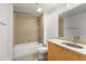 Well-lit bathroom featuring a bathtub, tiled walls, vanity with sink, and modern fixtures at 170 Boulevard Se # E006, Atlanta, GA 30312