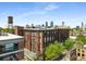 Brick apartment building with a water tower on top, showcasing city views, and mature trees under a clear blue sky at 170 Boulevard Se # E006, Atlanta, GA 30312