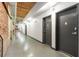 Long hallway featuring exposed brick wall and multiple entry doors, providing access to various units at 170 Boulevard Se # E006, Atlanta, GA 30312