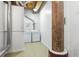 Bright laundry room featuring a washer, dryer, metal pipes, a wood support, and epoxy floors at 170 Boulevard Se # E006, Atlanta, GA 30312