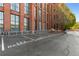 Exterior shot of parking spaces at a building with brick facade and large windows at 170 Boulevard Se # E006, Atlanta, GA 30312