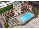 Aerial view of a luxurious outdoor pool and ample lounge seating nestled between gorgeous brick buildings at 170 Boulevard Se # E006, Atlanta, GA 30312