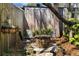 Backyard patio area with a stone fire pit and chairs offers a cozy outdoor setting amidst lush greenery at 218 Barry St, Decatur, GA 30030