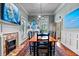 Bright dining room with a long wooden table, brick fireplace and charming decor at 218 Barry St, Decatur, GA 30030