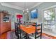 Spacious dining room with hardwood floors, large painting, and wooden table with black chairs at 218 Barry St, Decatur, GA 30030