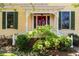 Close up of entrance with red door, white trim, and lush green tree at 218 Barry St, Decatur, GA 30030
