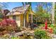 Charming cottage nestled in a lush garden with a flowing stream and artistic accents at 218 Barry St, Decatur, GA 30030
