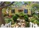Charming yellow home with lush landscaping, red door and brick pathway at 218 Barry St, Decatur, GA 30030