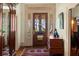 Cozy foyer with hardwood floors, wooden door and vintage accents at 218 Barry St, Decatur, GA 30030