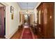 Long hallway with beautiful hardwood floors, rugs, and antique furniture at 218 Barry St, Decatur, GA 30030