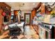 Rustic kitchen featuring wood cabinets, a farmhouse sink, and stainless steel appliances, with a dining area at 218 Barry St, Decatur, GA 30030