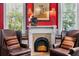 Cozy living room with a fireplace, two leather armchairs, and warm lighting at 218 Barry St, Decatur, GA 30030