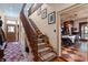 Carpeted staircase with wooden banister leads to the second floor, with a view of the dining room and front door at 218 Barry St, Decatur, GA 30030
