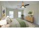 Stylishly decorated bedroom featuring bright walls, neutral carpet, ceiling fan, and natural light from two windows at 2241 Nottley Dr # 4, Marietta, GA 30066