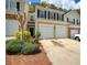 Traditional two-story townhome featuring a two car garage, neutral paint, and well-manicured landscaping at 2241 Nottley Dr # 4, Marietta, GA 30066