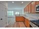 Bright kitchen with stainless steel appliances, wood cabinets, granite countertops, and hardwood flooring overlooking the living space at 2241 Nottley Dr # 4, Marietta, GA 30066