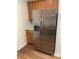 Stainless steel refrigerator with wood cabinets, tile backsplash, and granite countertops at 2241 Nottley Dr # 4, Marietta, GA 30066