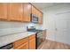 Well-lit kitchen featuring wooden cabinets, stainless steel appliances, granite countertops, and a tiled backsplash at 2241 Nottley Dr # 4, Marietta, GA 30066