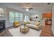 Bright living room featuring a fireplace, ceiling fan, and view of the outdoors at 2241 Nottley Dr # 4, Marietta, GA 30066