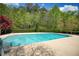 Large, refreshing community pool with clear blue water and surrounding lounge chairs at 2241 Nottley Dr # 4, Marietta, GA 30066