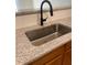 Close-up of a granite countertop with stainless steel sink and modern black faucet, complemented by a white subway tile backsplash at 2241 Nottley Dr # 4, Marietta, GA 30066