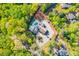 Overhead shot of a home surrounded by lush greenery highlighting the property's pool and driveway at 295 Hollyberry Dr, Roswell, GA 30076