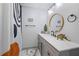 Charming bathroom with decorative shower curtain, gray vanity with marble countertop, and a round mirror at 295 Hollyberry Dr, Roswell, GA 30076