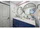 Nautical-themed bathroom features a dual sink vanity, decorative anchors, pelicans, and round mirrors at 295 Hollyberry Dr, Roswell, GA 30076