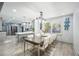 Dining area featuring a table for eight, chandelier and views of kitchen with gray cabinets and stainless appliances at 295 Hollyberry Dr, Roswell, GA 30076