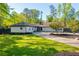Beautifully landscaped home exterior with well-manicured lawn and dark trim against the white siding at 295 Hollyberry Dr, Roswell, GA 30076