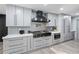 Gourmet kitchen features gray cabinets, a center island, modern appliances, and stylish herringbone backsplash at 295 Hollyberry Dr, Roswell, GA 30076