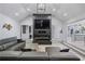 Open living area with modern fireplace, gray sofa, and views into the adjacent kitchen and dining space at 295 Hollyberry Dr, Roswell, GA 30076