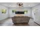 Living room featuring a neutral sofa, and updated ceiling fan with adjacent kitchen with refrigerator and two windows at 295 Hollyberry Dr, Roswell, GA 30076