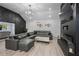 A living room showcasing a large gray sectional sofa, herringbone accent wall, and modern light fixture at 295 Hollyberry Dr, Roswell, GA 30076