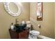 The bathroom includes a black glass sink above the cabinet with an oval mirror above the toilet at 3188 Paces Mill Se Rd, Atlanta, GA 30339
