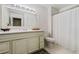 Bathroom features a white vanity, sink, toilet and tiled flooring at 3188 Paces Mill Se Rd, Atlanta, GA 30339
