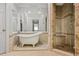 A luxurious bathroom is equipped with a soaking tub, a glass shower, and tiled walls at 3188 Paces Mill Se Rd, Atlanta, GA 30339