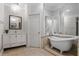 A clean bathroom features a white clawfoot tub, vanity with mirror, and tiled floors at 3188 Paces Mill Se Rd, Atlanta, GA 30339