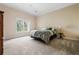 Bright bedroom featuring a cozy bed, bedside table, and a large window at 3188 Paces Mill Se Rd, Atlanta, GA 30339