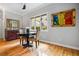 The dining area features a round table and chairs beneath a bright window, and colorful wall art at 3188 Paces Mill Se Rd, Atlanta, GA 30339