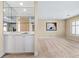 Dry bar with mirrored backdrop, white cabinets, and white countertop at 3188 Paces Mill Se Rd, Atlanta, GA 30339
