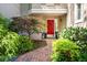 Charming entrance with a red front door, brick path, and manicured landscaping at 3188 Paces Mill Se Rd, Atlanta, GA 30339