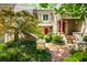 Inviting townhome with a brick path leading to a bright red door and lush landscaping at 3188 Paces Mill Se Rd, Atlanta, GA 30339