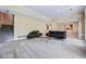 Open living room with stairs, plush carpet, black leather furniture and dry bar at 3188 Paces Mill Se Rd, Atlanta, GA 30339